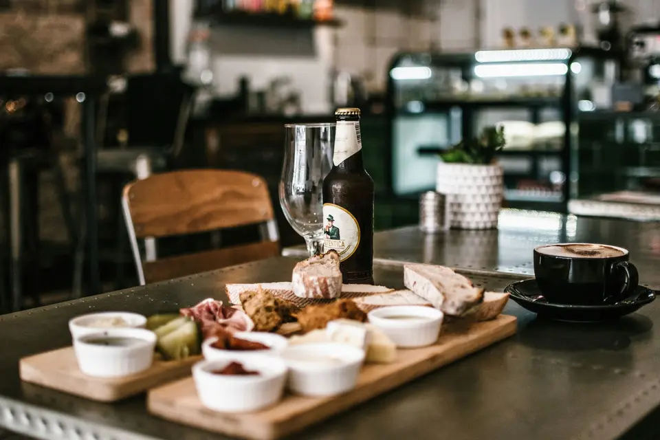 Coffee, a deli plate, and a drink on a cafe table