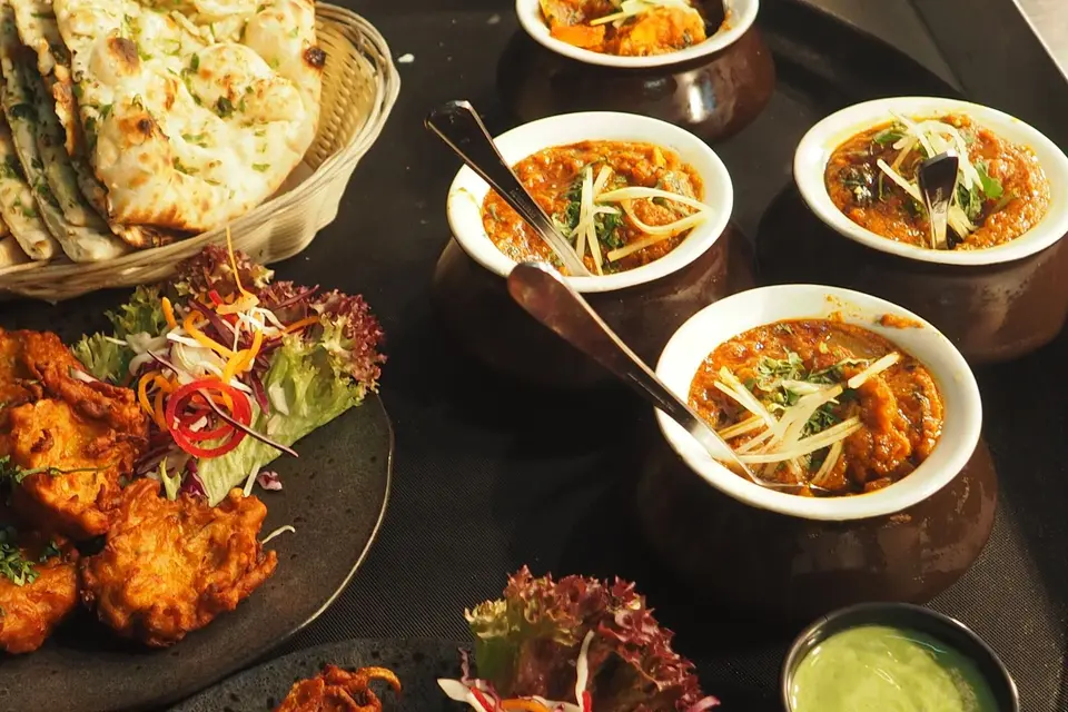 Indian dishes, naan, and curry on a table